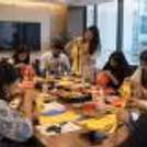 participants creating colourful paper lanterns during a hands-on lantern-making workshop.