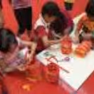 Group crafting colourful decorative lanterns together during a creative festive workshop.