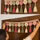traditional festive door toran using colourful pom-poms, beads, bells and decorative elements.