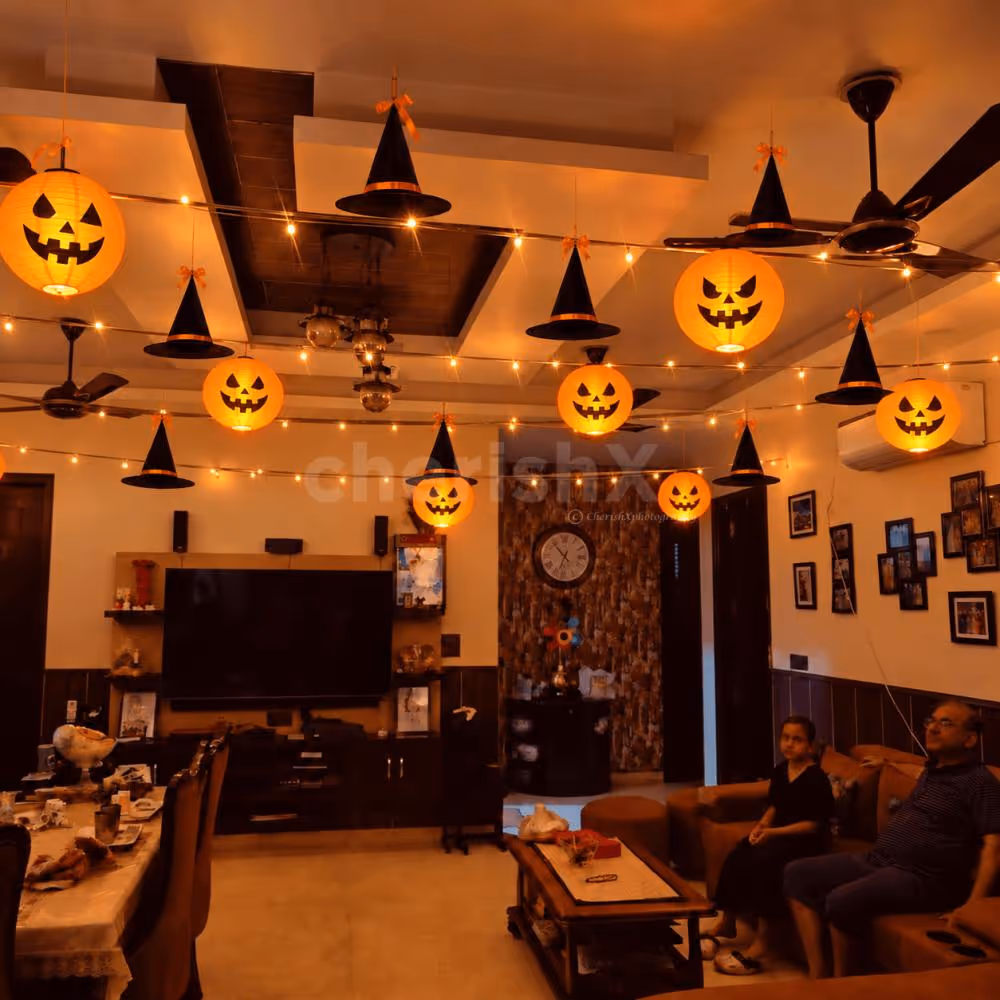 Elegant Halloween pumpkin lantern and witch hat decoration with warm LED lights.