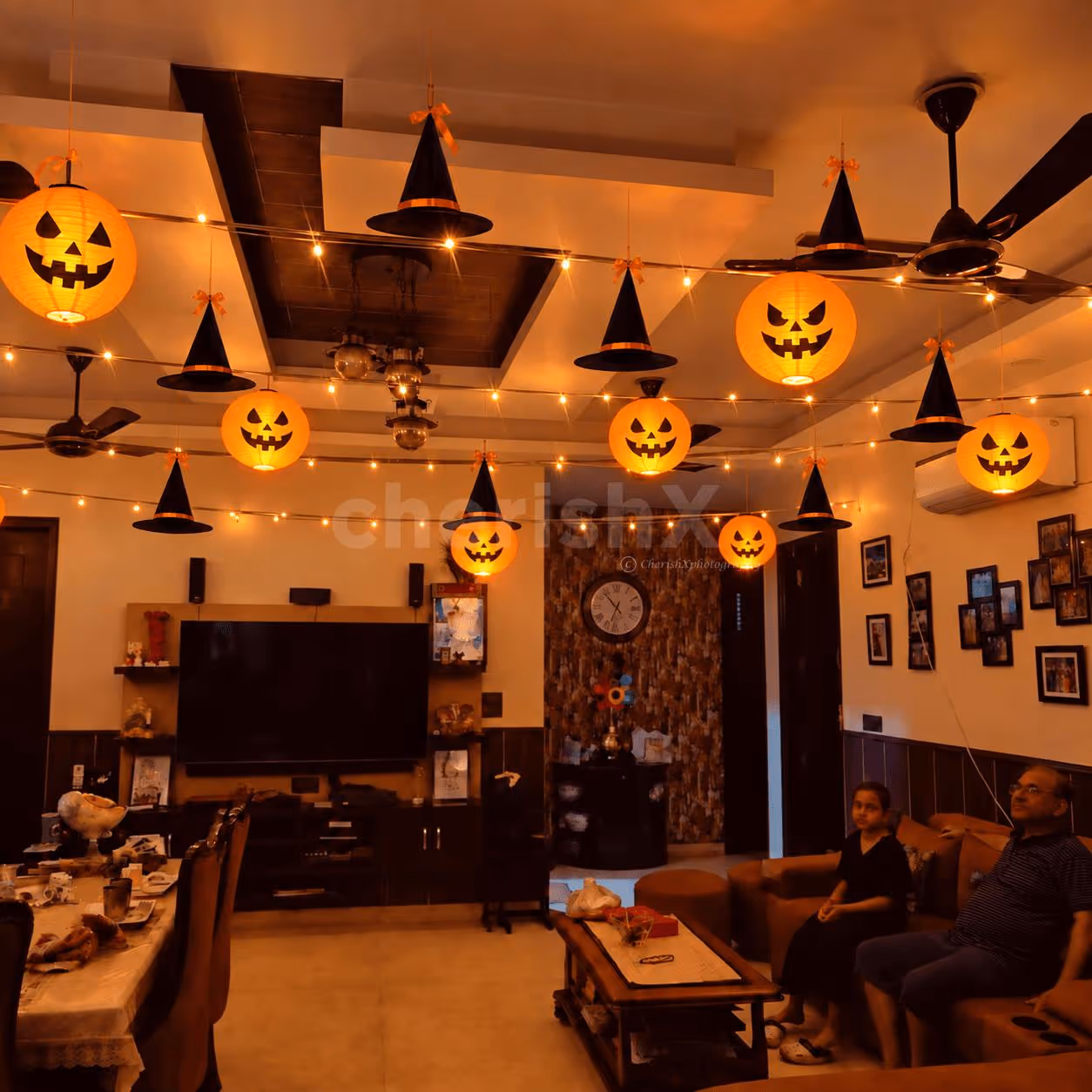 Elegant Halloween pumpkin lantern and witch hat decoration with warm LED lights.