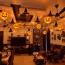 Elegant Halloween pumpkin lantern and witch hat decoration with warm LED lights.