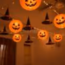 Halloween ceiling decoration with glowing jack-o’-lanterns and hanging witch hats for homes and party venues.