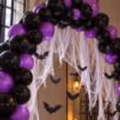 Purple and black Halloween balloon arch setup for home and party venues