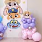 Zootopia customized flex with pastel balloon arch and character cutouts.