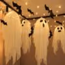 Create a spooky party atmosphere with lightweight fabric ghosts, black bat cutouts and fairy lights