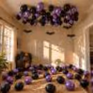 Halloween ceiling decor with metallic black, chrome purple balloons and hanging bats