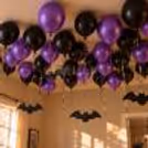 Halloween party balloon setup with ceiling balloons and bat cutouts