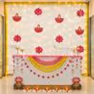 Elegant Pink Lotus Diwali Reception Decoration with Yellow Marigold Garlands and Warm Lights.