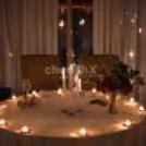 Intimate Karwa Chauth celebration with elegant table decor, flowers and candlelight.