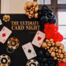 Red, black and gold card party backdrop.