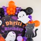 Orange, black and purple balloons create a hauntingly fun setup.