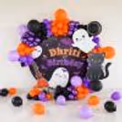 Metallic and purple chrome balloons add a striking Halloween touch.