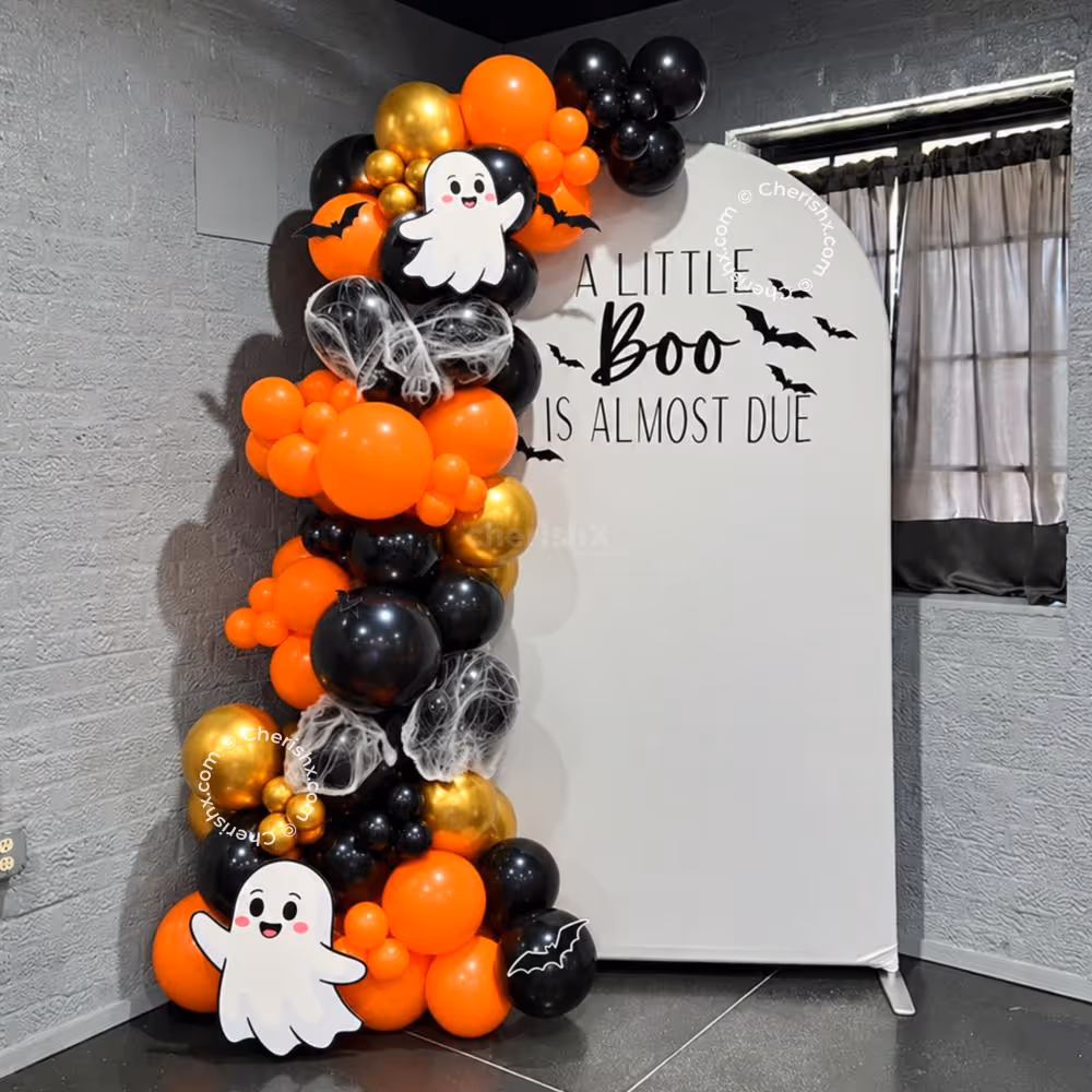 Halloween balloon arch in orange, black and golden chrome with a customized party backdrop.