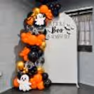 Halloween balloon arch in orange, black and golden chrome with a customized party backdrop.