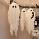 Candles, spiderweb details and white skull props complete this haunted party decor.