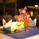 Luxury poolside dining experience with beautiful floral decorations and candles at Holiday Inn.
