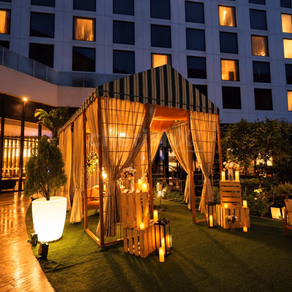 1. Luxury private gazebo decorated with warm candlelight and sheer curtains for a romantic dinner experience.