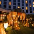 1. Luxury private gazebo decorated with warm candlelight and sheer curtains for a romantic dinner experience.