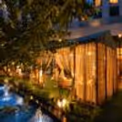 Luxury romantic dining experience in an outdoor gazebo with candlelit décor and a beautifully illuminated setting.