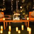 Luxury outdoor dining experience with glowing candles, floral arrangements, and an intimate garden ambiance.