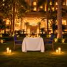 Romantic Karwa Chauth garden candlelight dinner at The Grand, Vasant Kunj, New Delhi, featuring an elegant outdoor dining setup.
