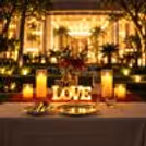Elegant romantic table decoration featuring candles, red roses and illuminated LOVE letters for Karwa Chauth at The Grand Hotel Delhi.