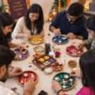 Kids and adults decorating colourful thalis using flowers, beads, And Decorative Materials For Festive Thali Decoration.