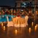 Luxury poolside dinner date in Gurgaon featuring candlelit table decoration and a romantic hotel setting.