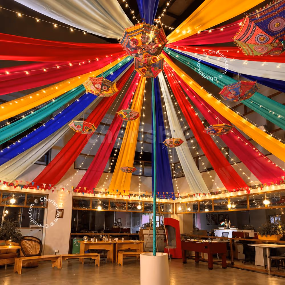 Colourful ceiling decoration with traditional umbrellas and fairy lights