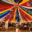 Colourful ceiling decoration with traditional umbrellas and fairy lights
