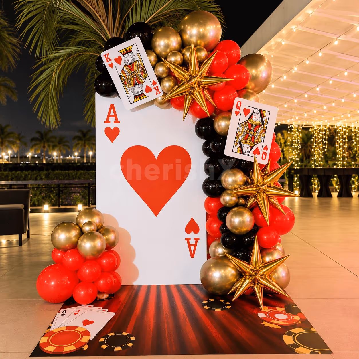 Casino Ace of Hearts party backdrop with red, black and gold balloon decorations