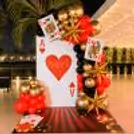 Casino Ace of Hearts party backdrop with red, black and gold balloon decorations