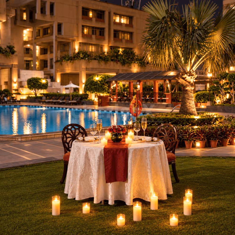 Romantic poolside candlelight dinner setup for two at Eros Hotels, South Delhi, with elegant table décor.