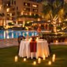 Romantic poolside candlelight dinner setup for two at Eros Hotels, South Delhi, with elegant table décor.
