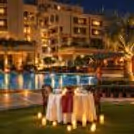 Poolside candlelight dining experience with a 4-course meal and unlimited soft drinks at Eros Hotels.