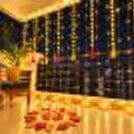Typical Diwali Balcony Decor with Yellow Bud garlands, warm Fairy lights, and designer Rangoli