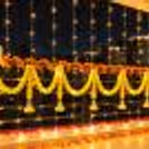 A hanging decoration of orange marigold and yellow floral strings attached to balcony railings.