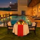 The Rose Affair romantic dining experience featuring a beautifully decorated table, floral arrangements, and candlelight.