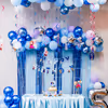 Blue frill curtains and balloon bunches set cheerful birthday vibes