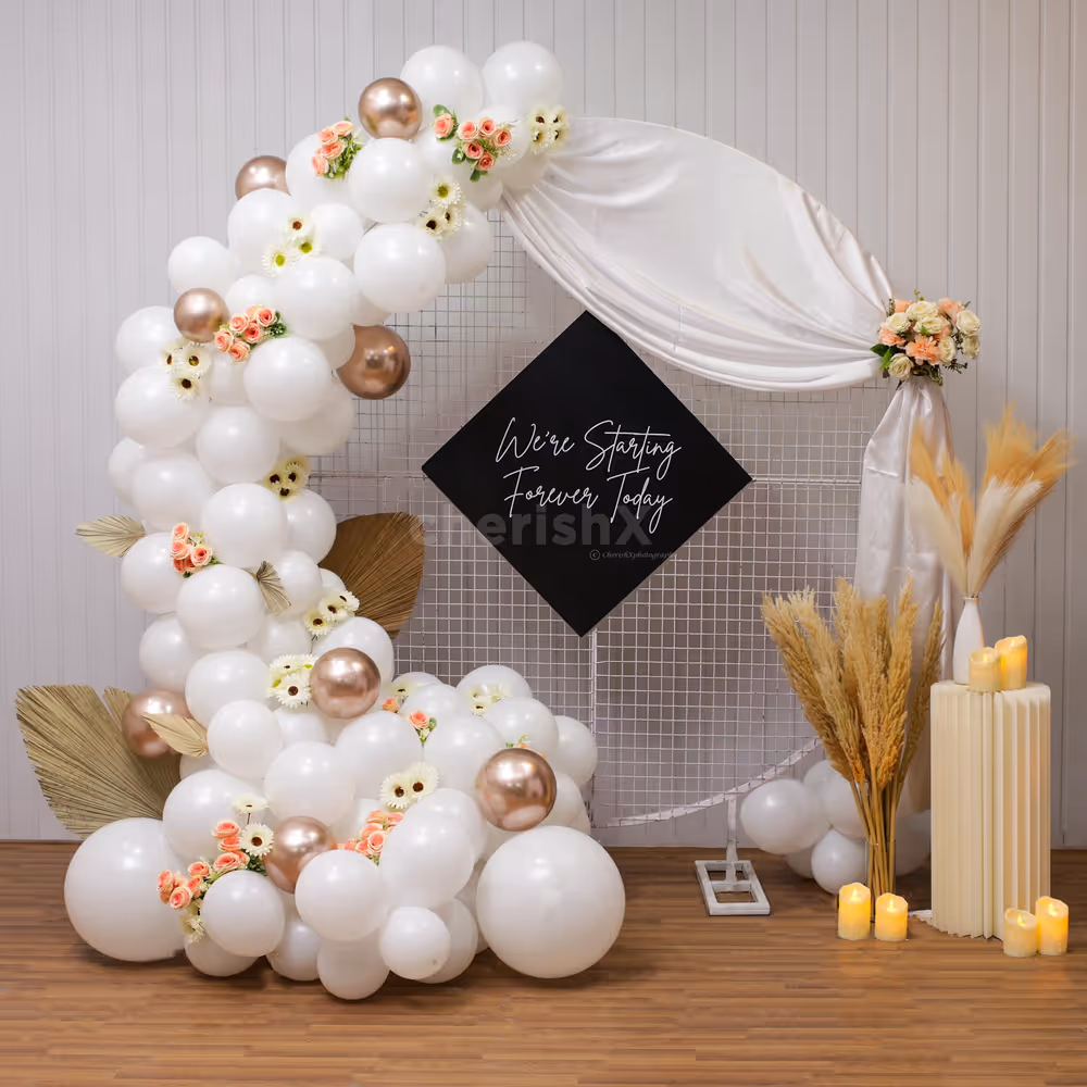 Enhance ambiance with leaves, Champagne and white balloons decor for Engagement