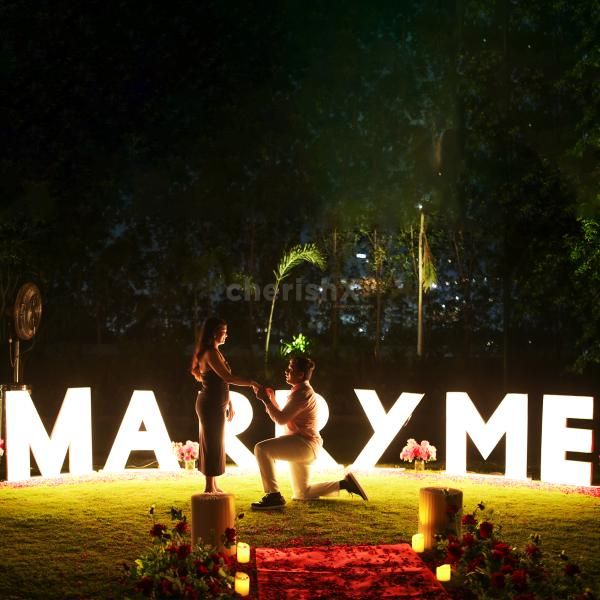 Grand bold "Marry Me" marquee lights take center stage