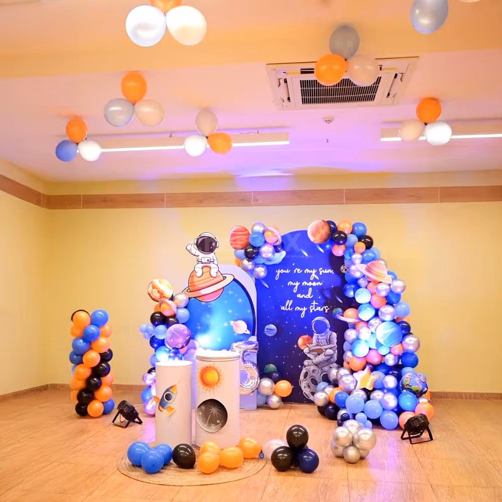 Cosmic balloon arch in silver blue orange and black.