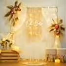 Pampas and boho drapery around a warm "Oh Baby" neon sign.