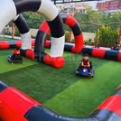 Kids Go-karting setup with inflatable colorful boundaries forms vibrant racetrack