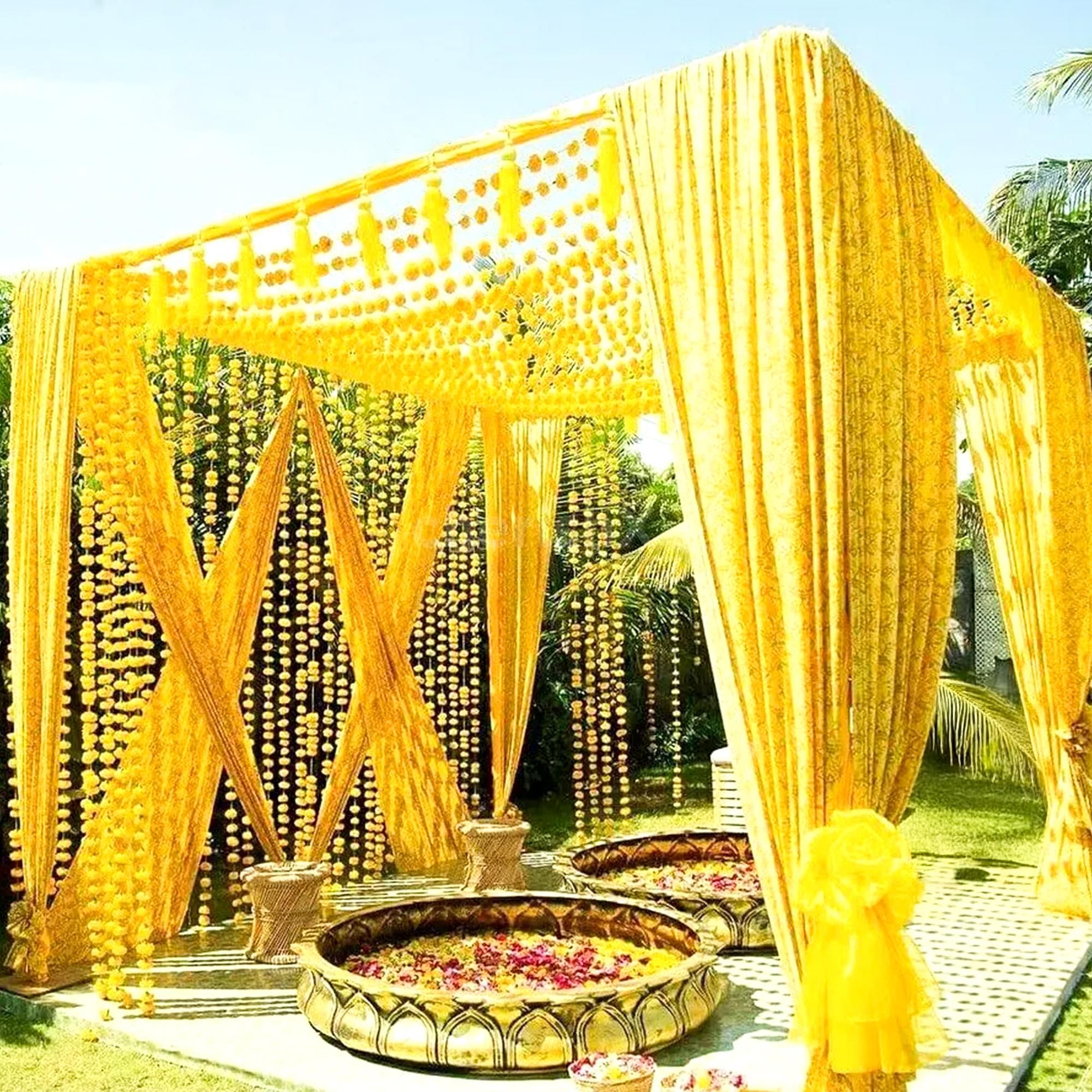 Twin urli bowls are placed centrally for haldi or mehendi rituals.