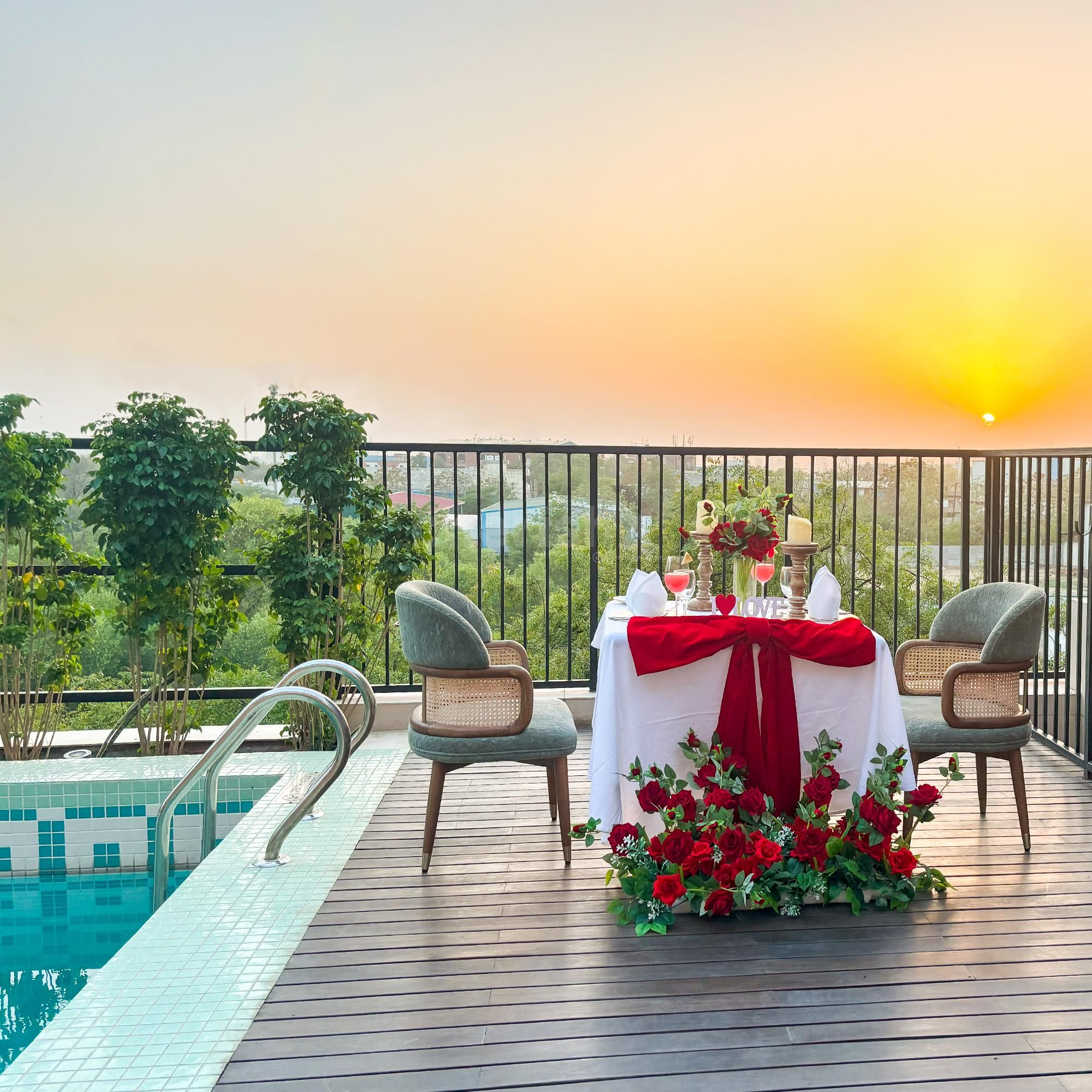 Romantic dining by the pool with roses, candlelight, and love in the air