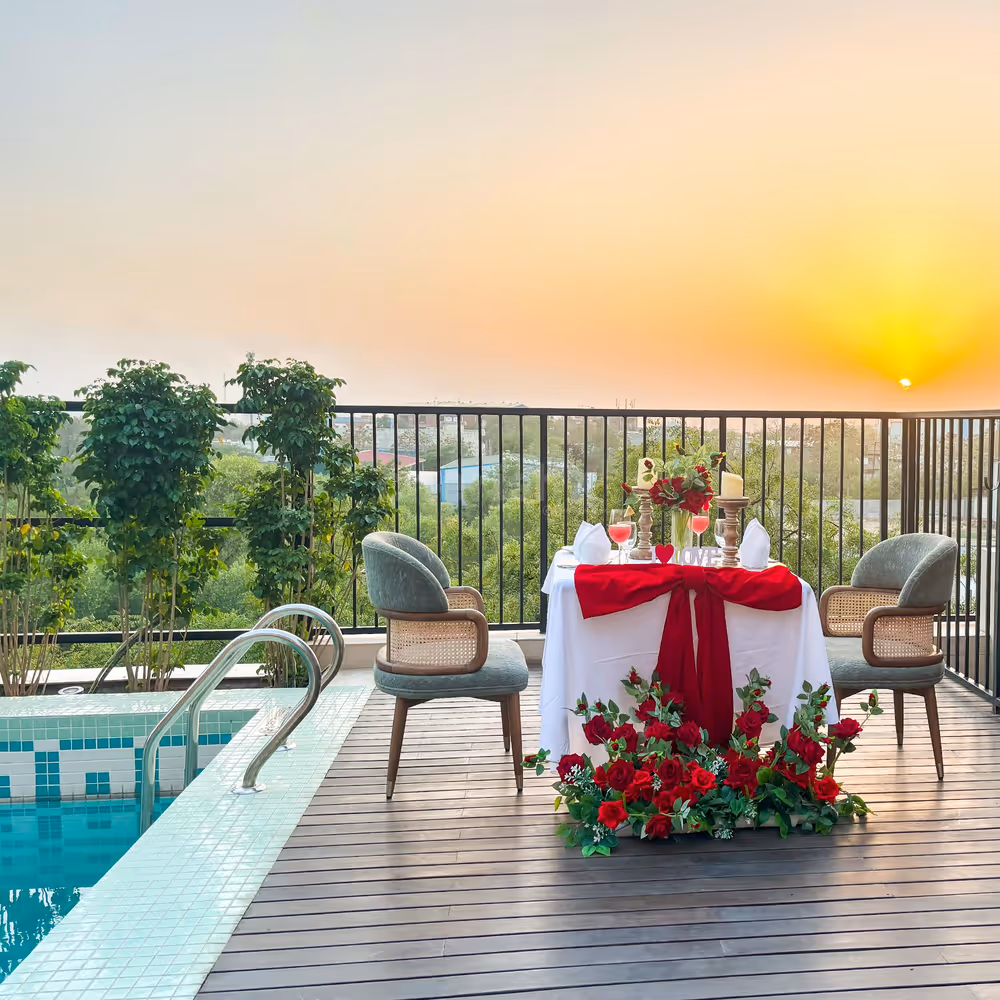 Romantic dining by the pool with roses, candlelight, and love in the air