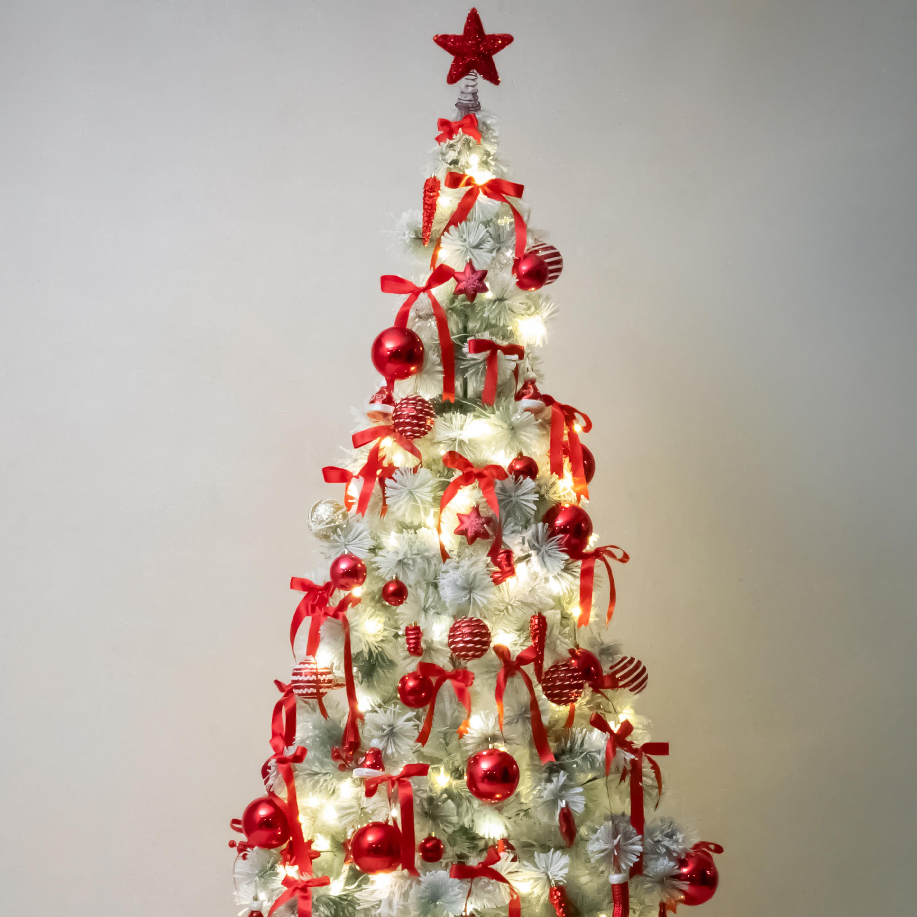 Hanging Red and golden ornaments from the tree branches create a balanced look