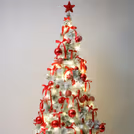 Hanging Red and golden ornaments from the tree branches create a balanced look